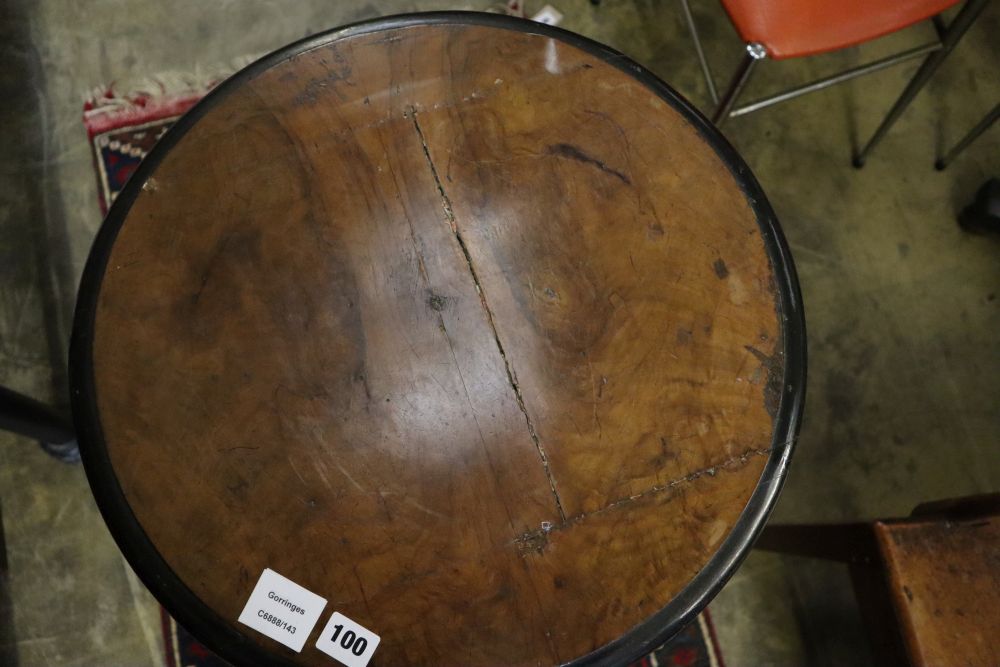 A Regency gilt and ebonised circular walnut occasional table, on triple rams head support, diameter 47cm, height 78cm